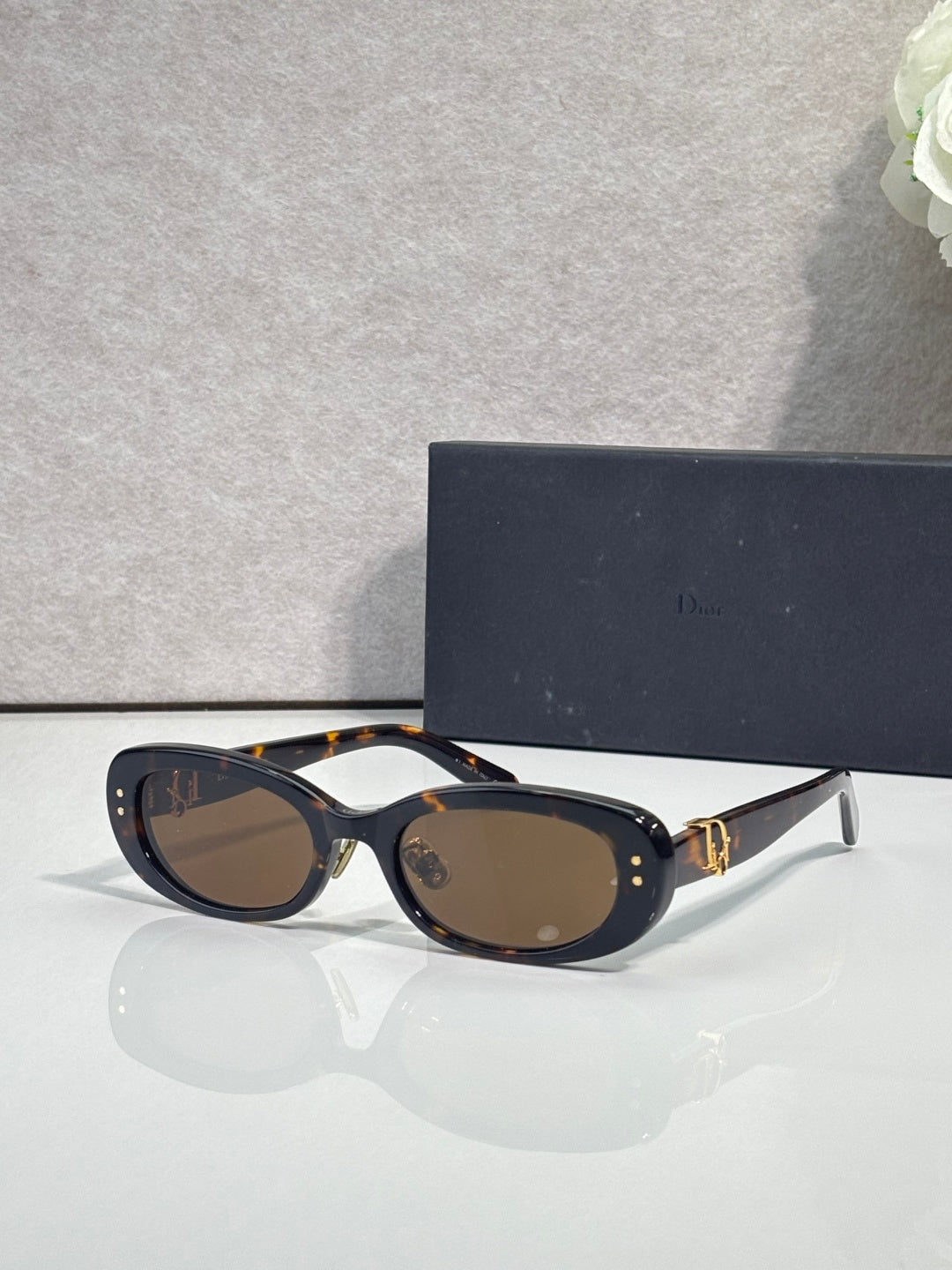 Dior tortoiseshell oval sunglasses with brown lenses and gold-tone hinge