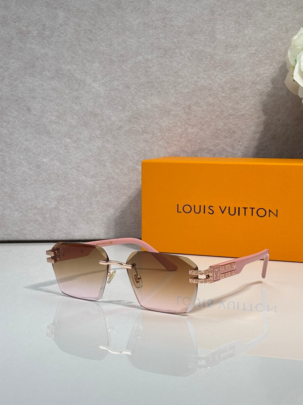 Louis Vuitton glasses with pink frames and light gradient lenses, gold logo hardware