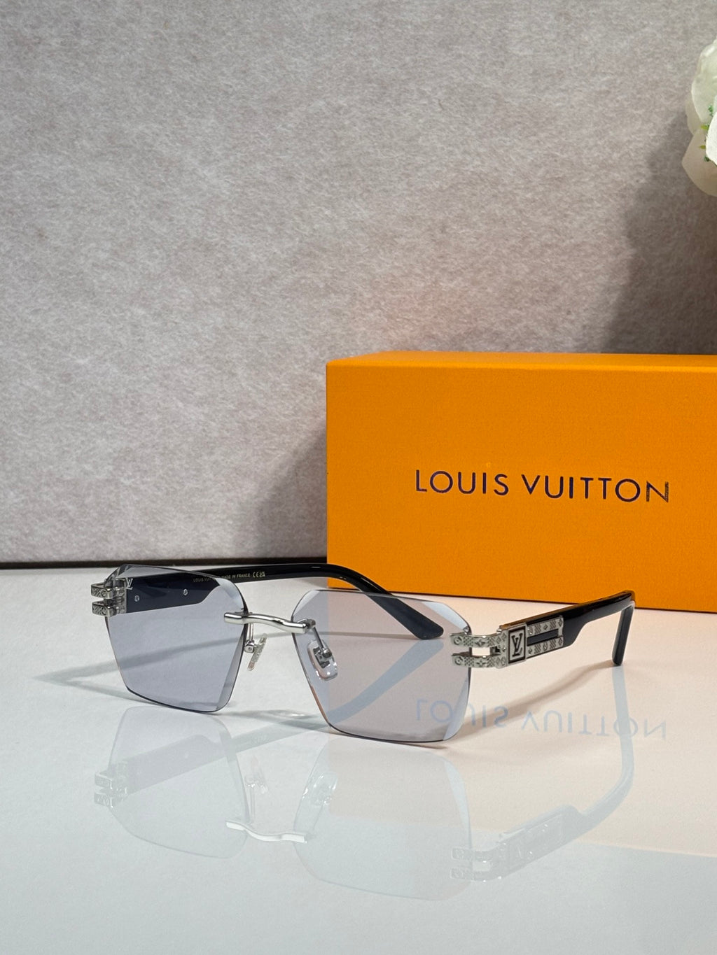 Louis Vuitton glasses with dark frames and clear gradient lenses, gold logo details