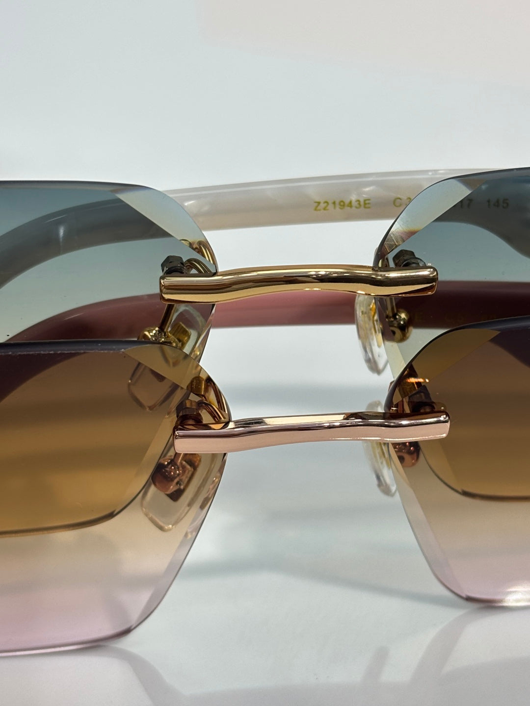 Louis Vuitton glasses close-up with gold bridge and gradient lenses in dark and light tones