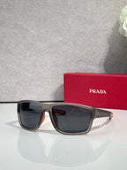Prada sunglasses with dark lenses and dark tortoise frame, with red Prada case