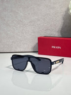 Prada oversized rectangular sunglasses with dark frames and blue-tinted lenses