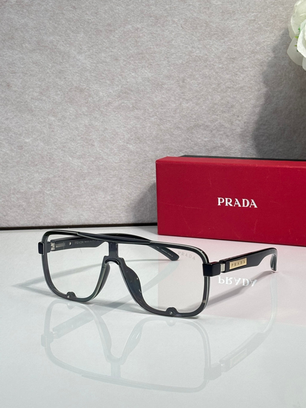 Prada rectangular eyeglasses with black frames and clear lenses, front view