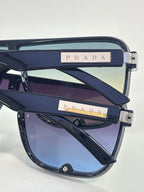 Prada rectangular sunglasses with blue lenses and metal logo bars on temples