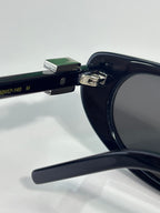 Close-up of sunglasses temple with size markings on dark frame