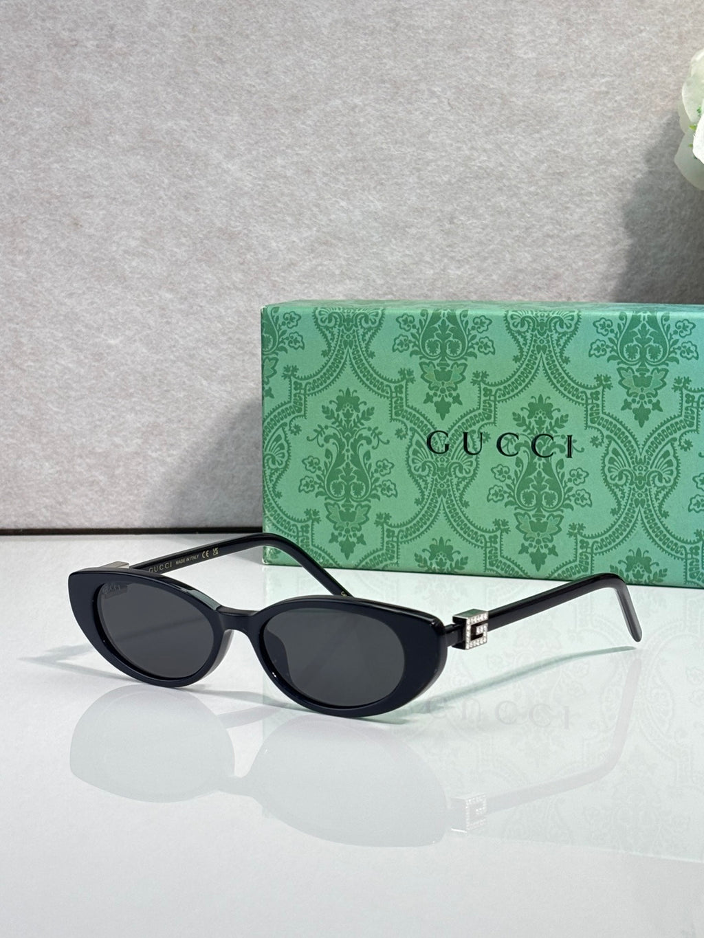 Cat-eye sunglasses with dark frames and dark-tinted lenses, temple arms visible
