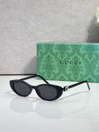 Cat-eye sunglasses with dark frames and dark-tinted lenses, temple arms visible