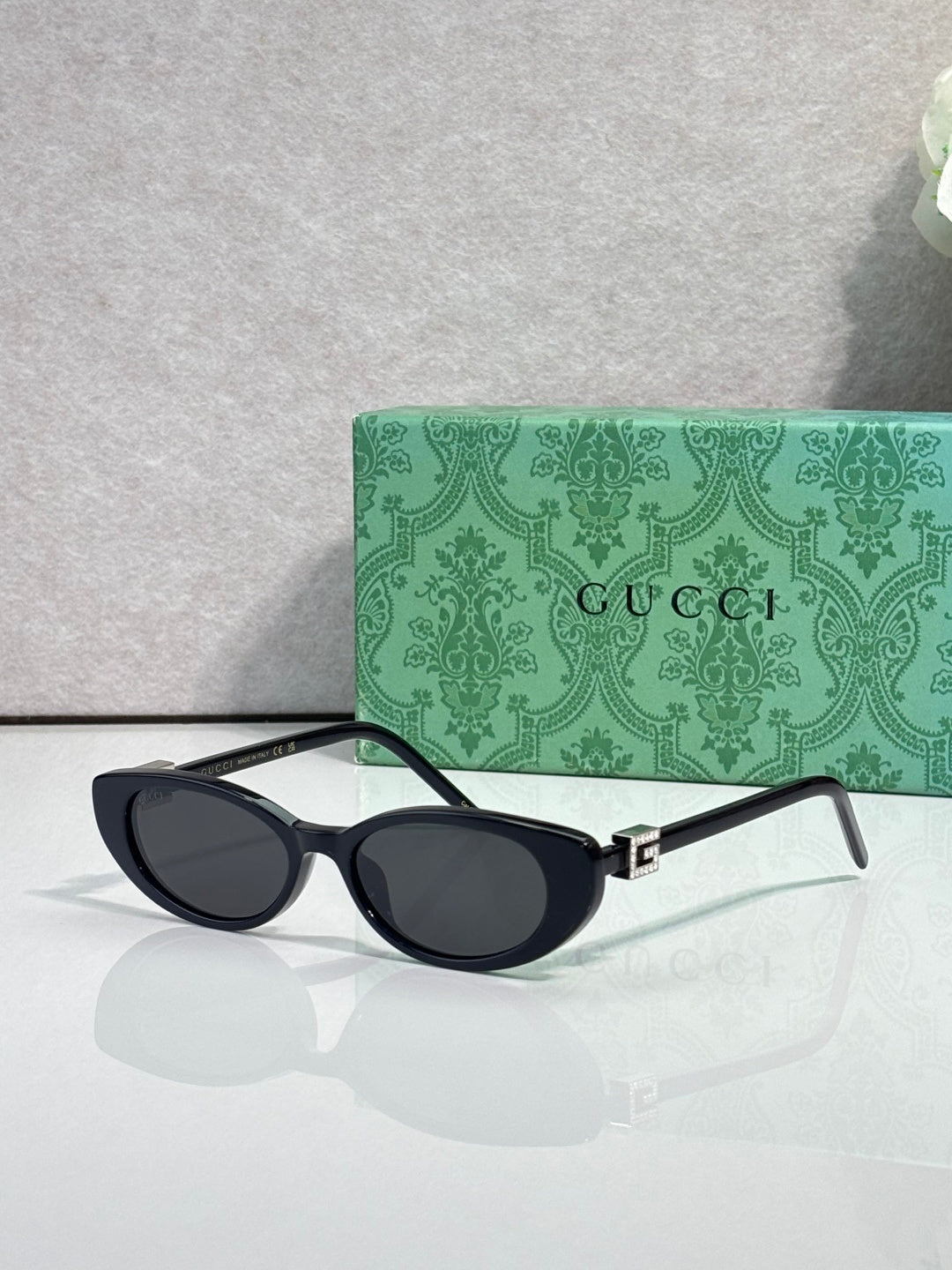 Cat-eye sunglasses with dark frames and dark-tinted lenses, temple arms visible