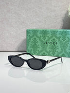 Cat-eye sunglasses with dark frames and dark-tinted lenses, side profile view