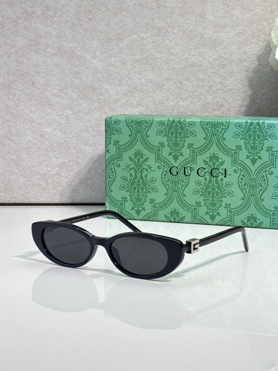 Cat-eye sunglasses with dark frames and dark-tinted lenses, side profile view