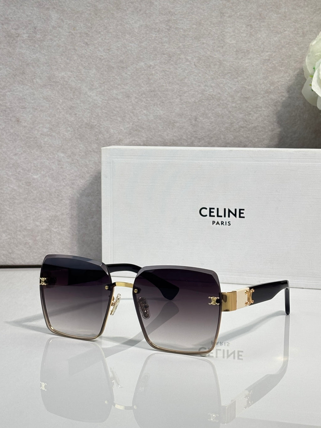 Square sunglasses with gold-tone frame and dark black gradient lenses