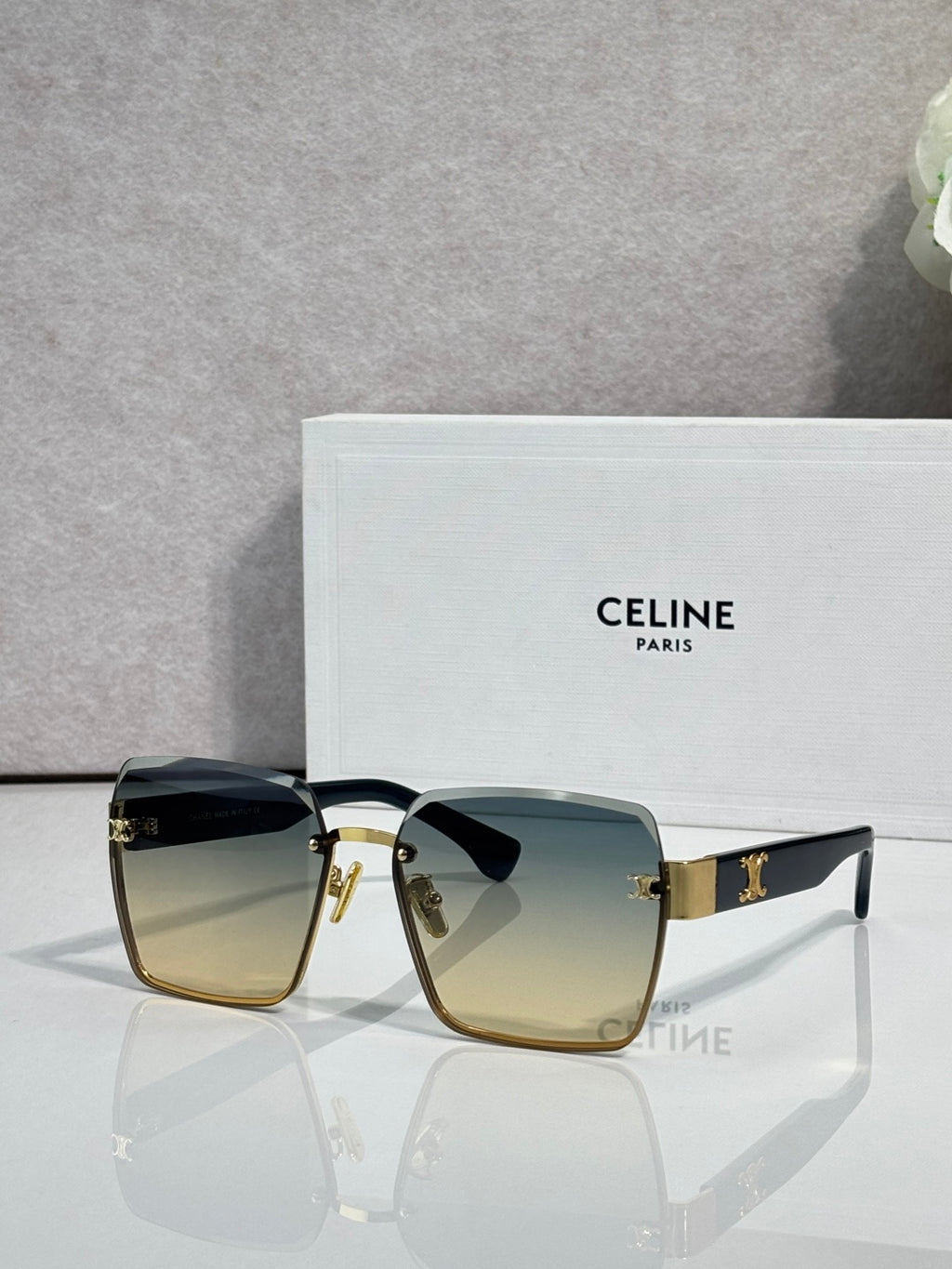 Square sunglasses with gold-tone frame and blue-green gradient lenses