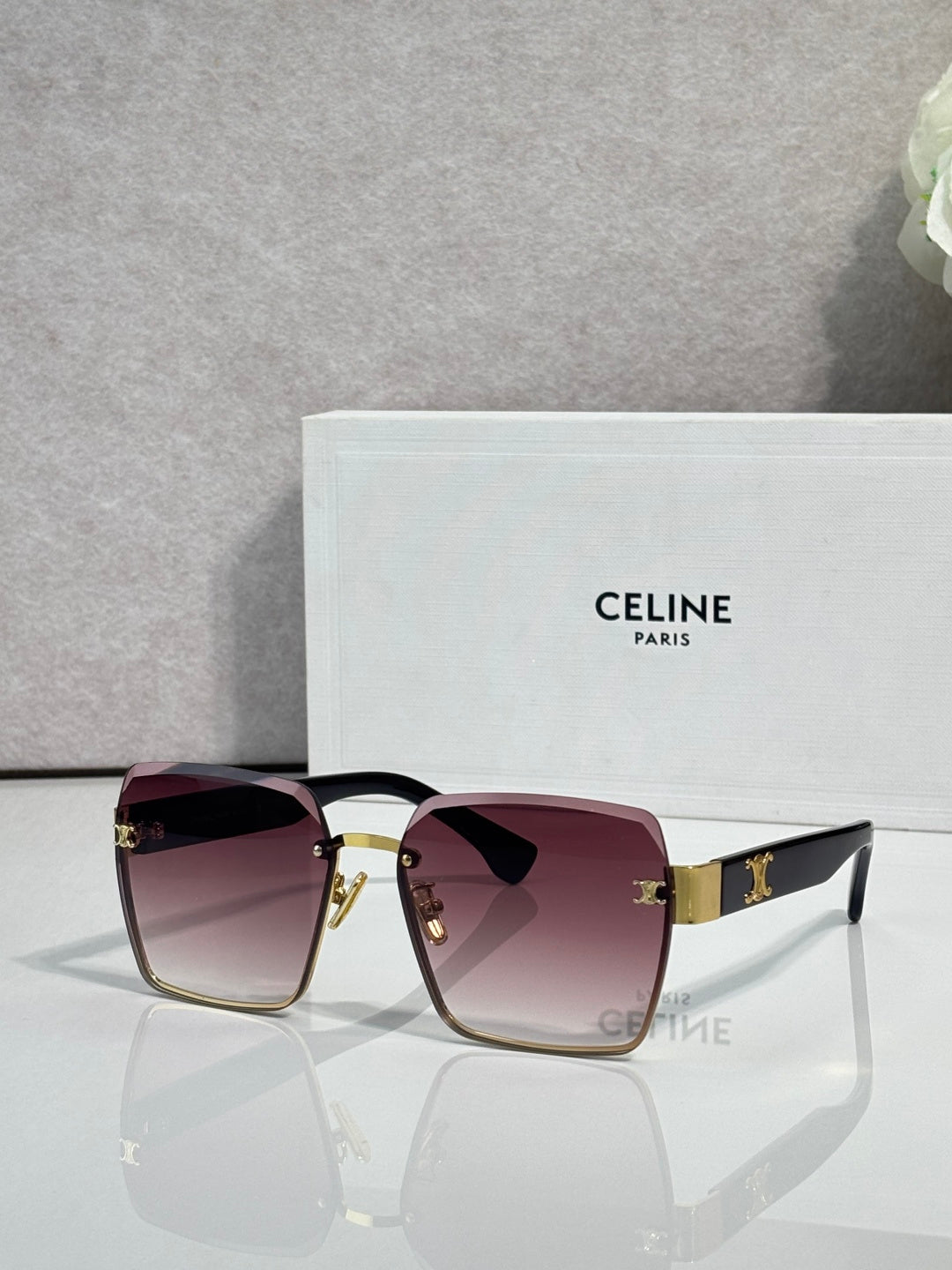 Square sunglasses with gold-tone frame and deep red gradient lenses