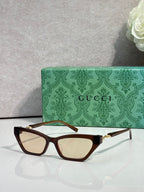 Tortoiseshell cat-eye glasses with light lenses and gold-tone hinges