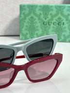 Cat-eye glasses pair: light blue with dark lenses and red with pink lenses