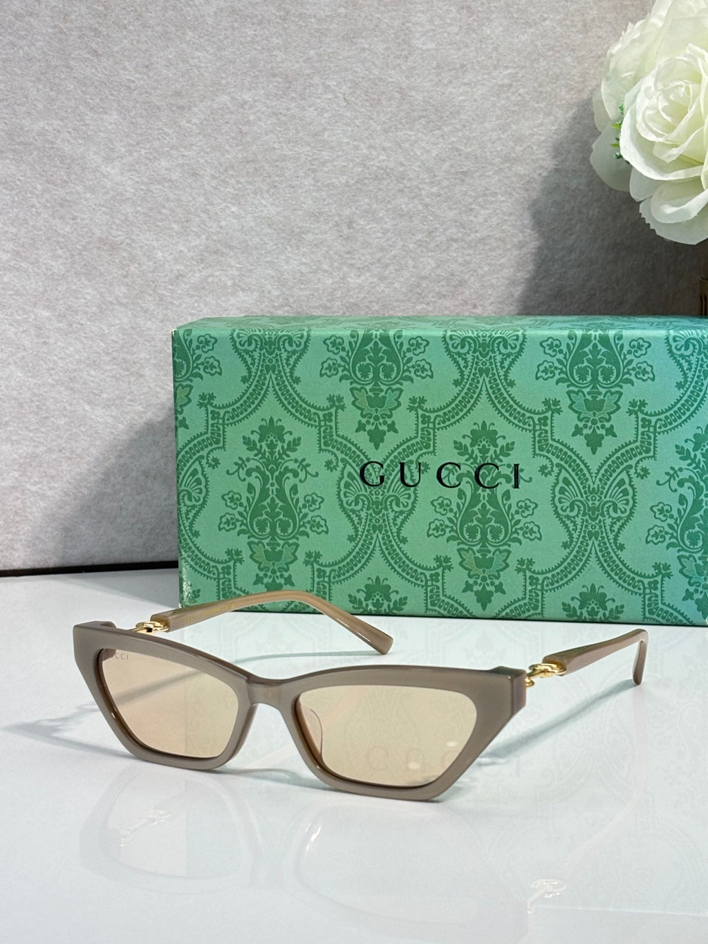 Tortoiseshell cat-eye glasses with beige lenses and gold-tone hinges