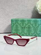 Red cat-eye glasses with pink-tinted lenses and gold-tone hinges