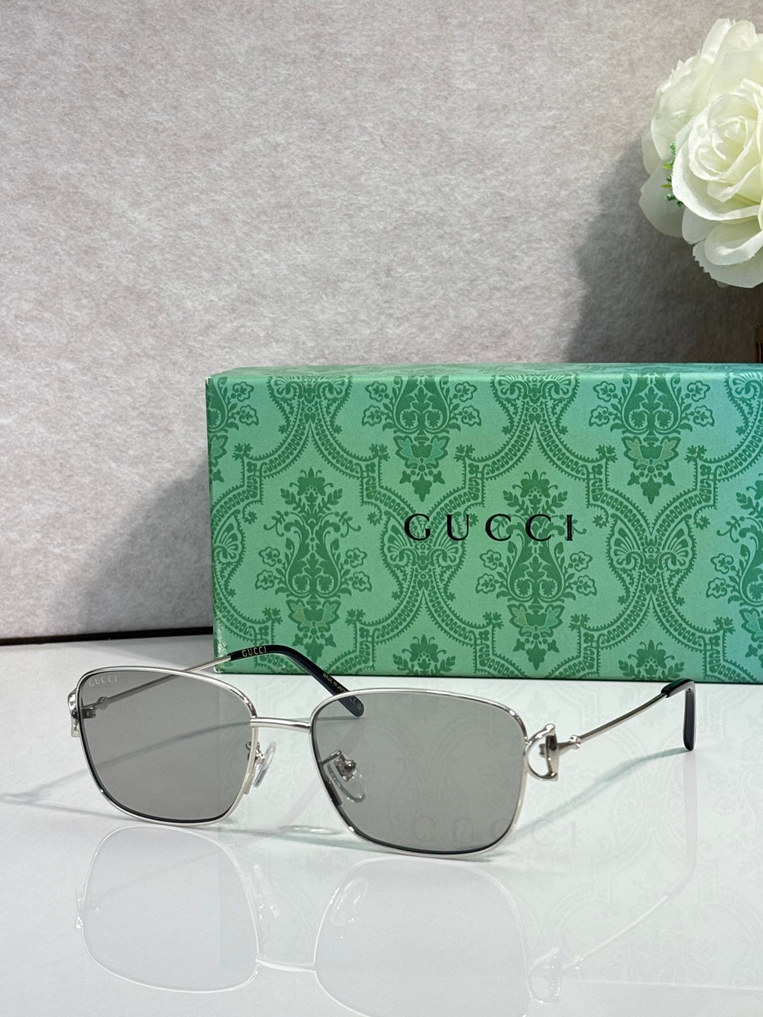 Gucci sunglasses with gray tinted lenses and silver frame