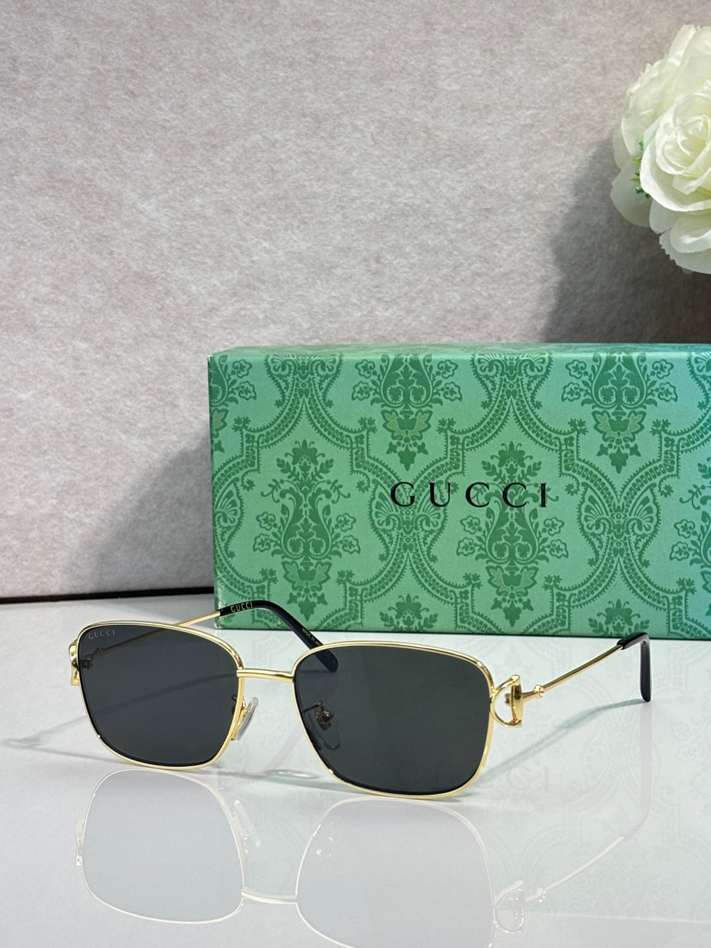 Gucci sunglasses with gold frame and dark lenses