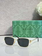 Gucci sunglasses with gold frame and dark lenses
