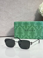 Gucci sunglasses with black lenses and black-and-silver frame