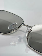 Gucci sunglasses close-up of metal frame hinge with dark lenses