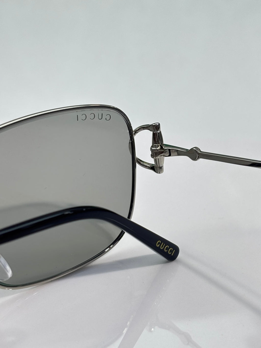 Gucci sunglasses close-up of temple with GUCCI marking and dark lenses