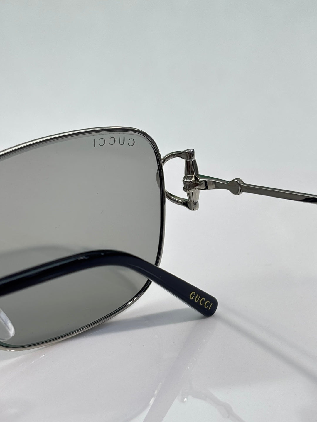 Gucci sunglasses close-up of temple with GUCCI marking and dark lenses