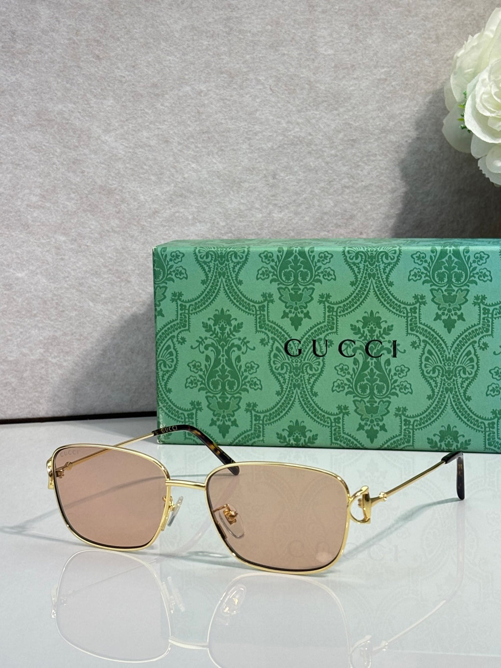 Gucci sunglasses with gold frame and light brown tinted lenses