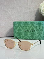 Gucci sunglasses with gold frame and light brown tinted lenses