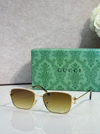 Gucci sunglasses with gold frame and warm yellow tinted lenses