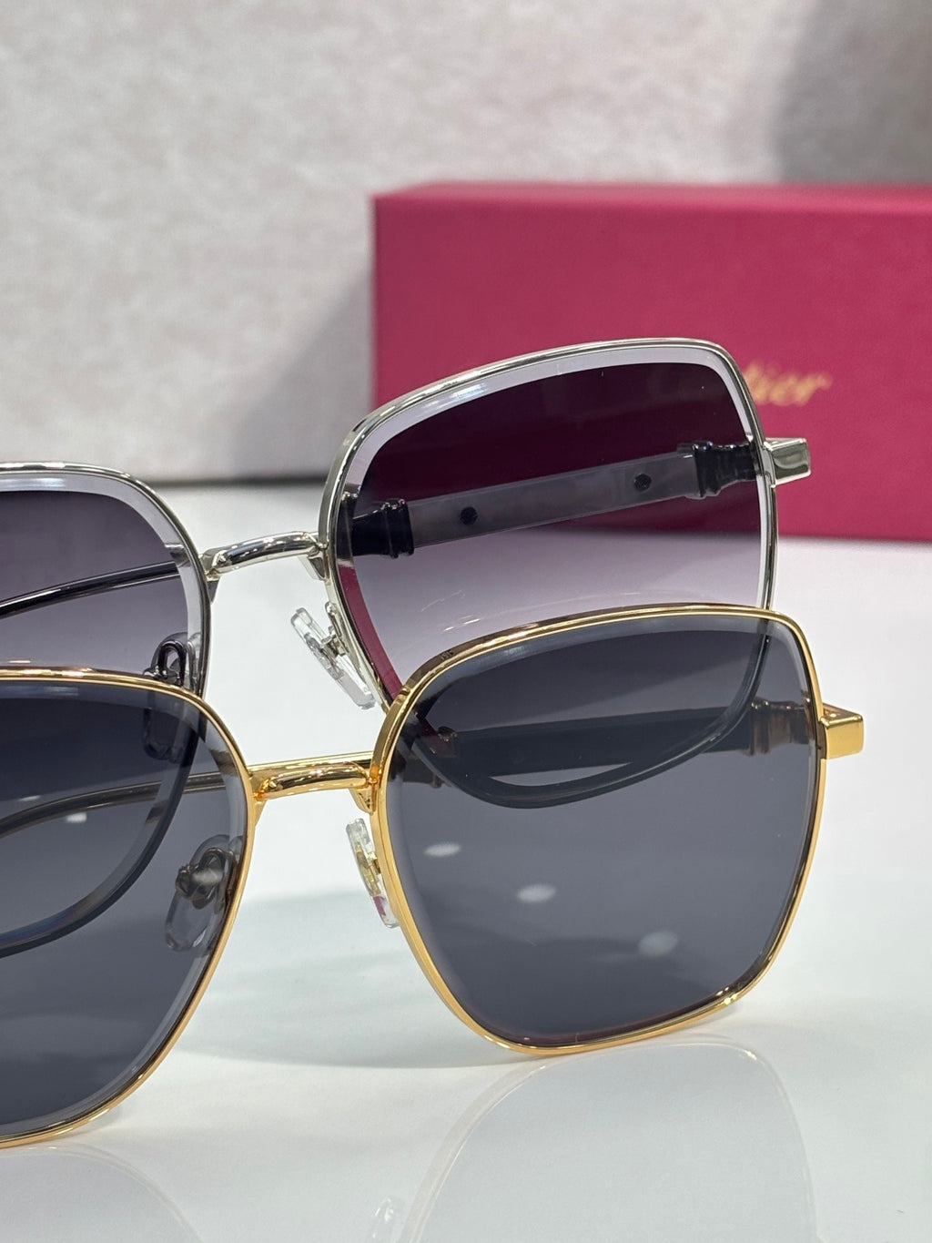 Cartier sunglasses shown from angles: silver and gold frames with dark lenses