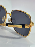 Cartier sunglasses side detail with gold arms and blue front accents