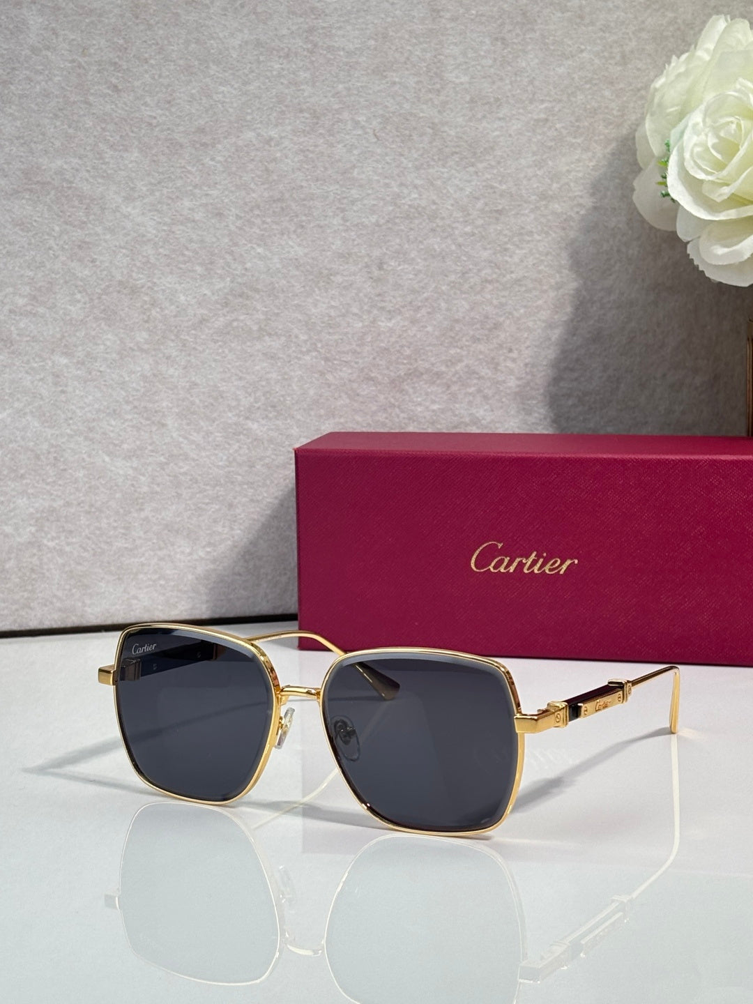 Cartier sunglasses with gold frame and dark blue tinted lenses