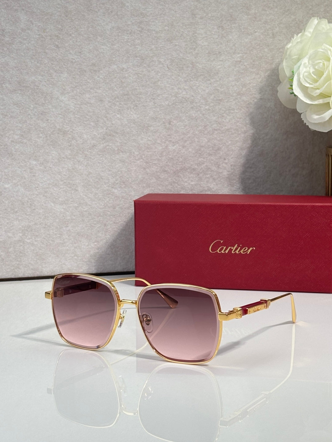 Cartier sunglasses with gold frame and pink-tinted lenses