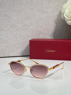 Gold-tone round sunglasses with rose-pink lenses