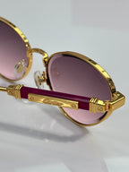 Gold-tone round sunglasses with purple lenses and logo temple detail