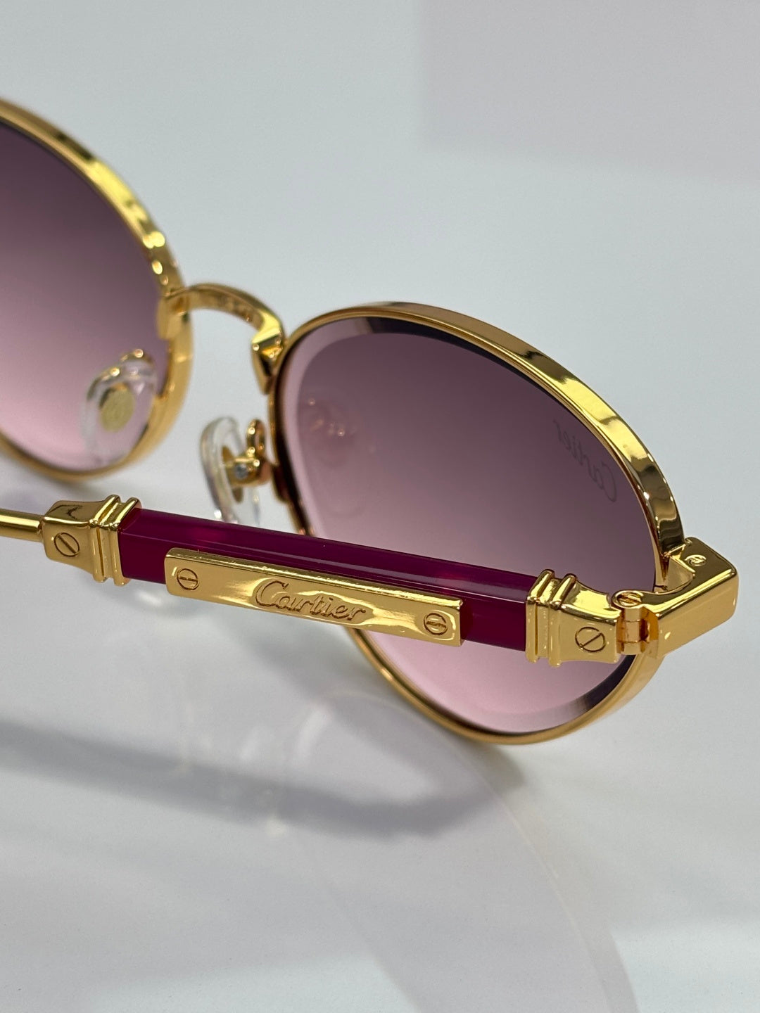 Gold-tone round sunglasses with purple lenses and logo temple detail