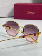 Round sunglasses with gold frame, burgundy temple, and purple-tinted lenses