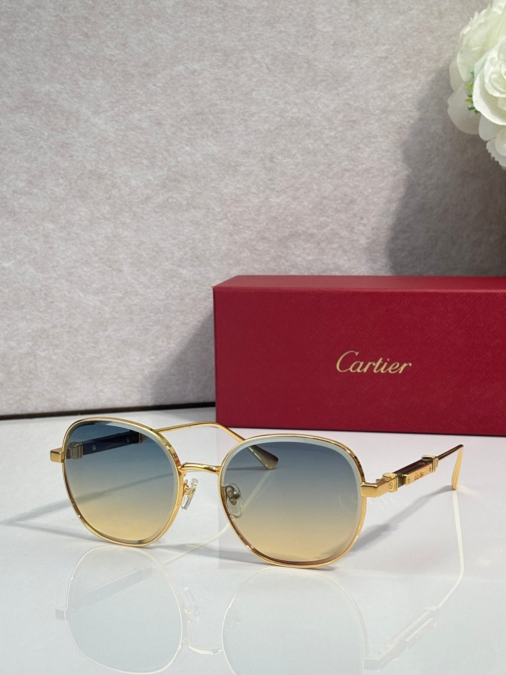 Gold-tone round sunglasses with light amber tinted lenses