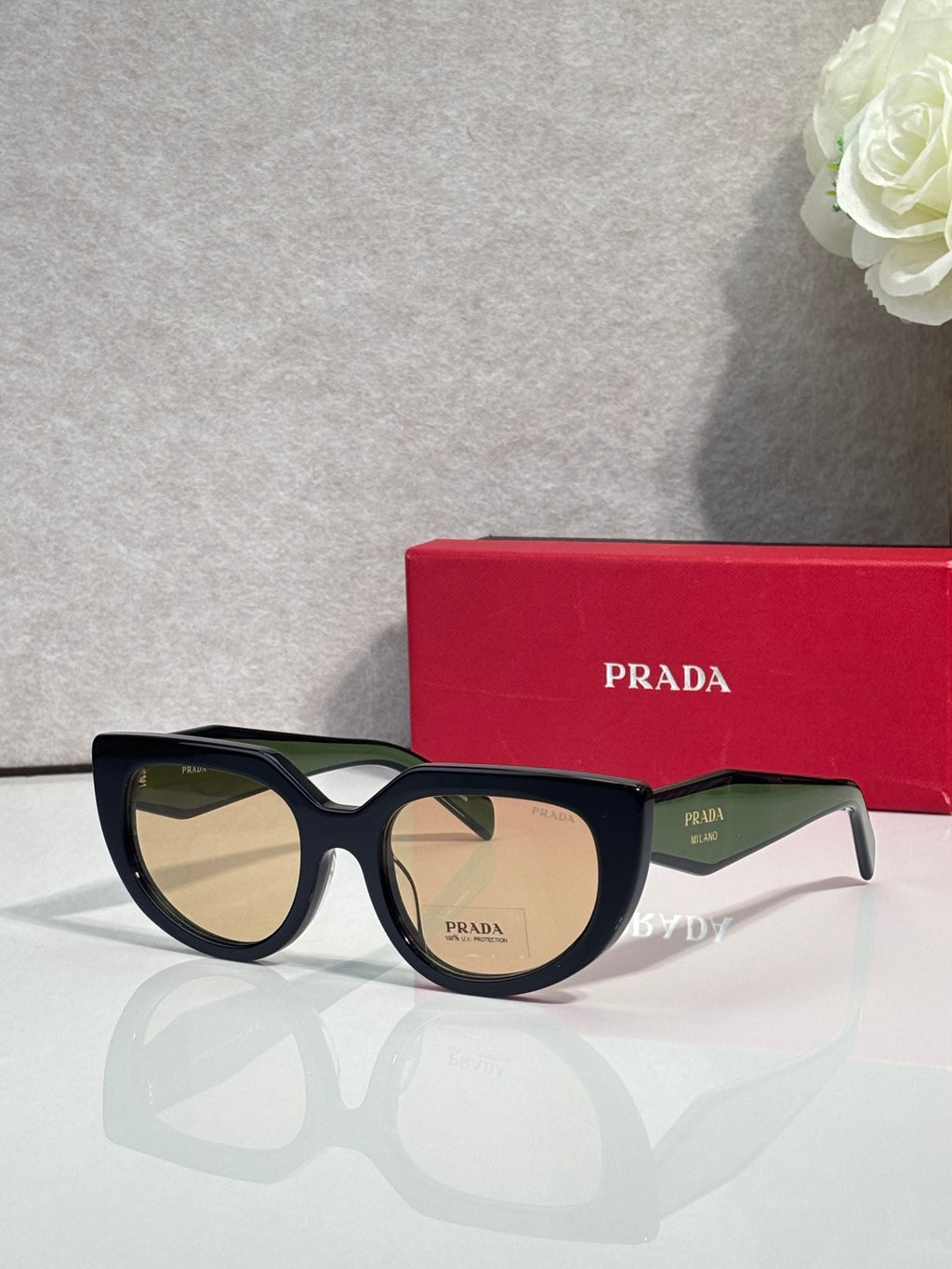 Cat-eye sunglasses with tortoiseshell frame and amber-tinted lenses