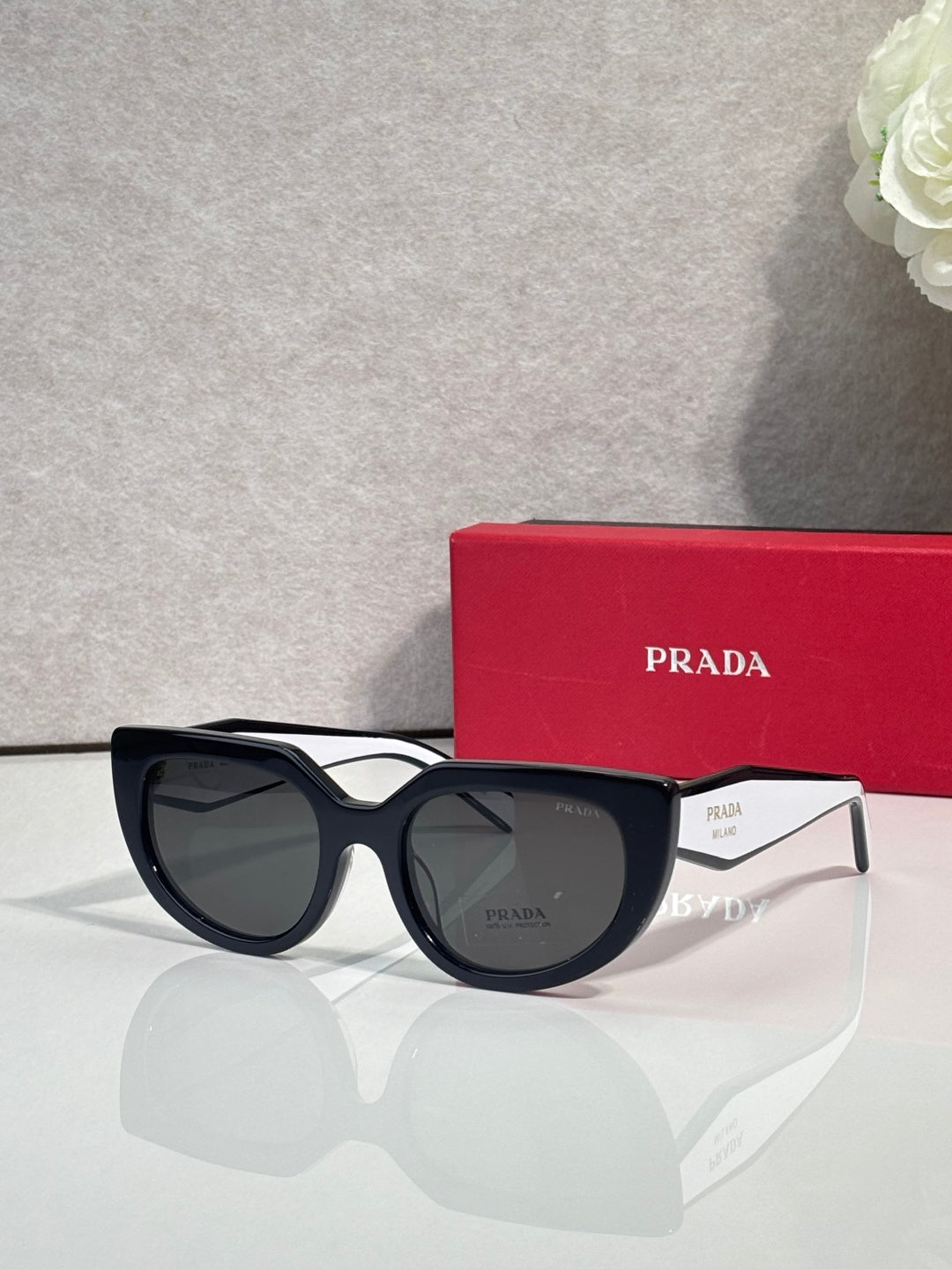 Cat-eye sunglasses with black frame and dark lenses