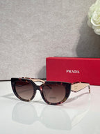 Cat-eye sunglasses with tortoiseshell frame and dark-tinted lenses