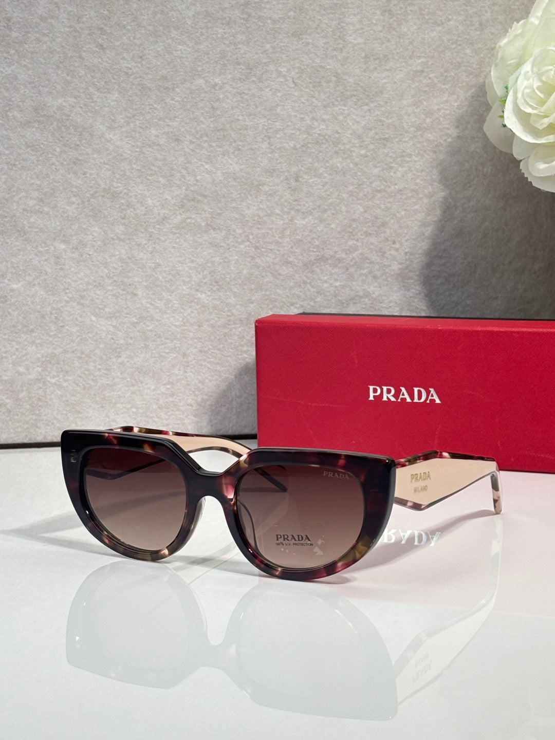 Cat-eye sunglasses with tortoiseshell frame and dark-tinted lenses