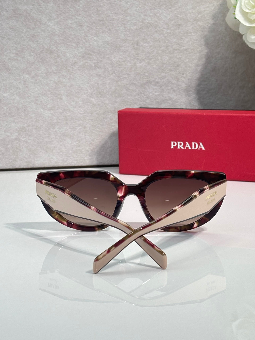 Cat-eye sunglasses with tortoiseshell frames and dark-tinted lenses