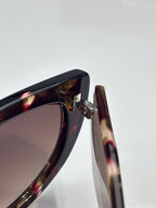 Cat-eye sunglasses close-up of tortoiseshell frame and metal hinge