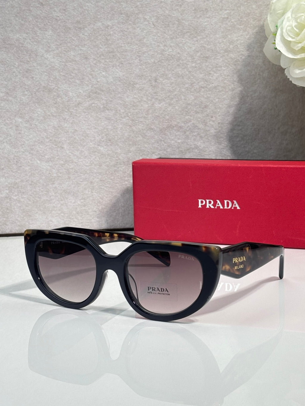 Cat-eye sunglasses with black frame and dark-tinted lenses