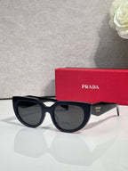 Cat-eye sunglasses with black frames and smoky gray lenses