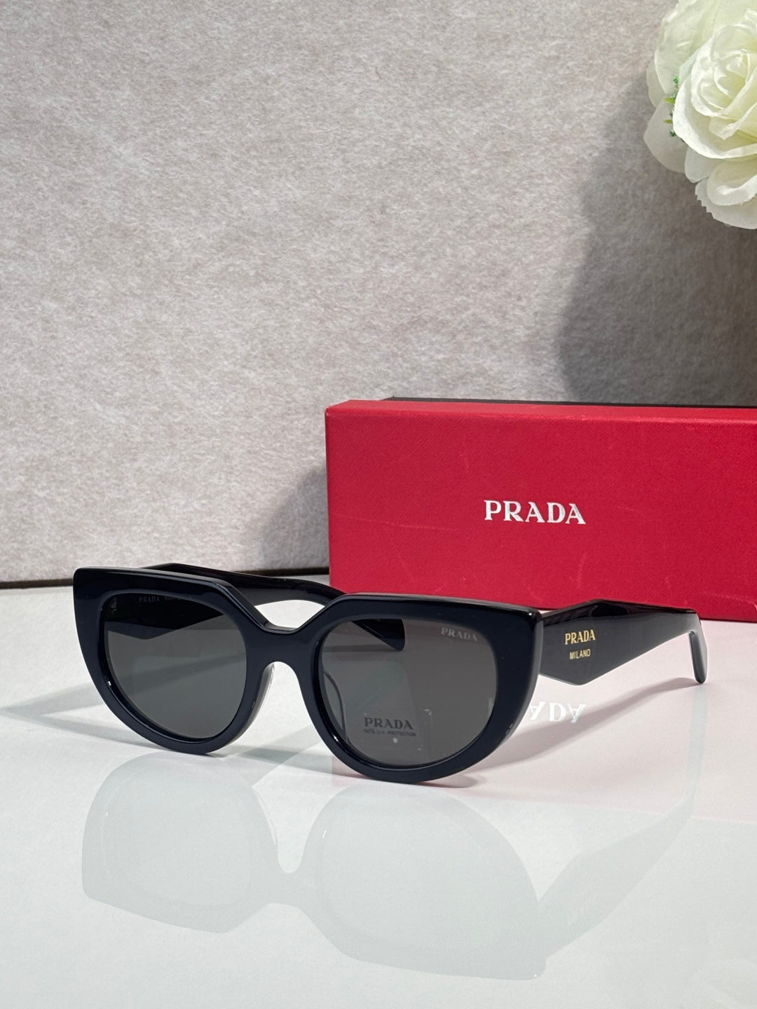 Cat-eye sunglasses with black frames and smoky gray lenses
