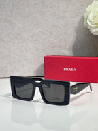 Prada sunglasses, black square frames with dark lenses in front view.